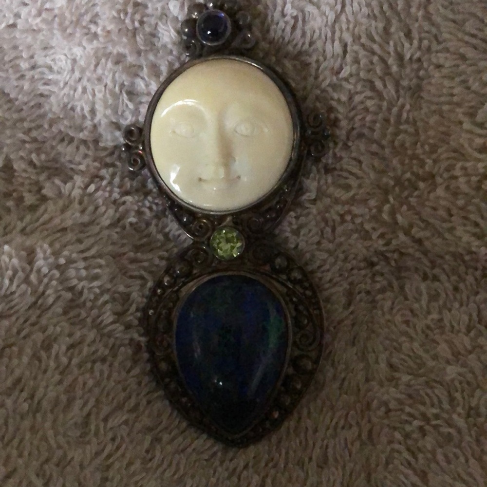 Carved bone man in the moon pendant/brooch